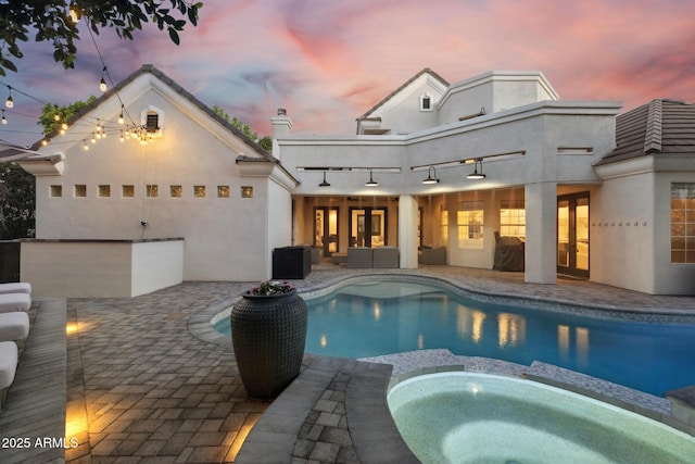 2625 N 24th St Unit 15, Mesa, AZ 85213 - pool at dusk with french doors, a patio, and a pool with connected hot tub