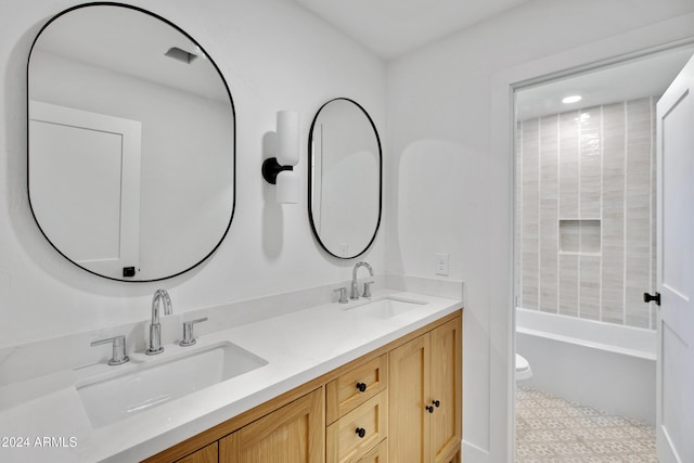 full bath featuring double vanity, a bathtub, a sink, and tile patterned floors