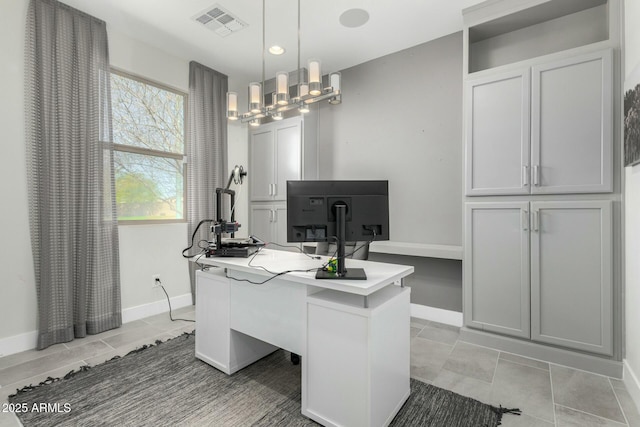 office area with light tile patterned floors, visible vents, a notable chandelier, and baseboards