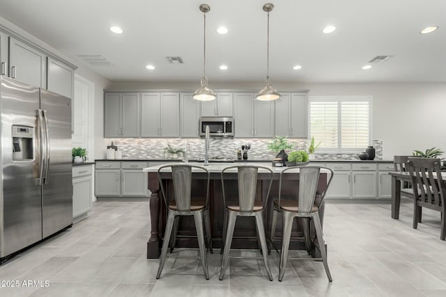 kitchen with visible vents, appliances with stainless steel finishes, and gray cabinets