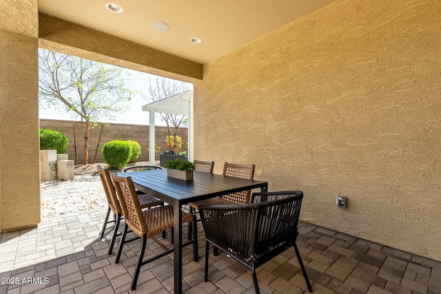 view of patio / terrace with outdoor dining space and fence