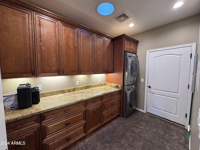 laundry area with stacked washer and clothes dryer