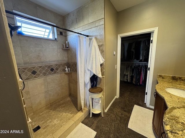 bathroom featuring vanity and curtained shower