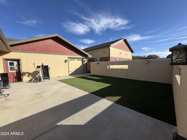 view of yard featuring a patio and a garage