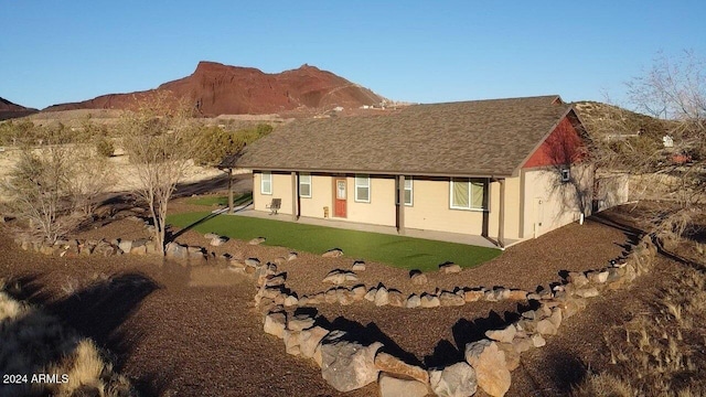 back of house featuring a mountain view