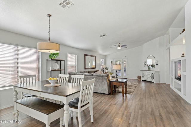 dining room featuring ceiling fan, vaulted ceiling, and hardwood / wood-style floors