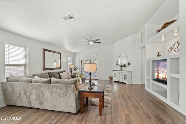 living room featuring ceiling fan, lofted ceiling, built in features, and dark hardwood / wood-style flooring