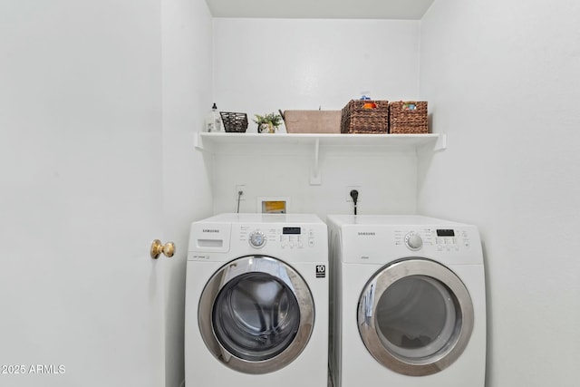 clothes washing area with washer and clothes dryer