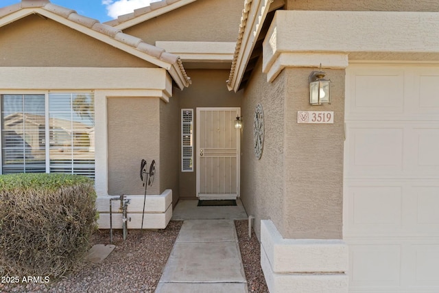 view of exterior entry featuring a garage