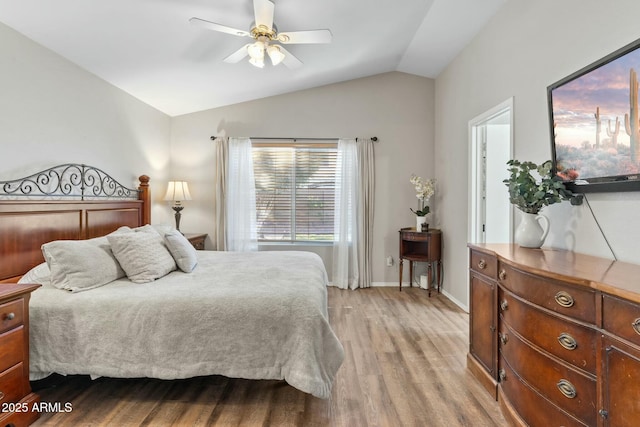 bedroom featuring ceiling fan, vaulted ceiling, and light wood-type flooring