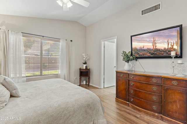 bedroom with lofted ceiling, ceiling fan, and light hardwood / wood-style floors