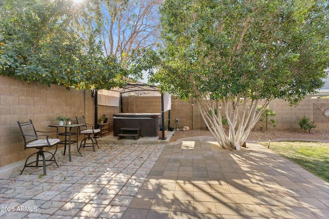 view of patio featuring a gazebo and a hot tub