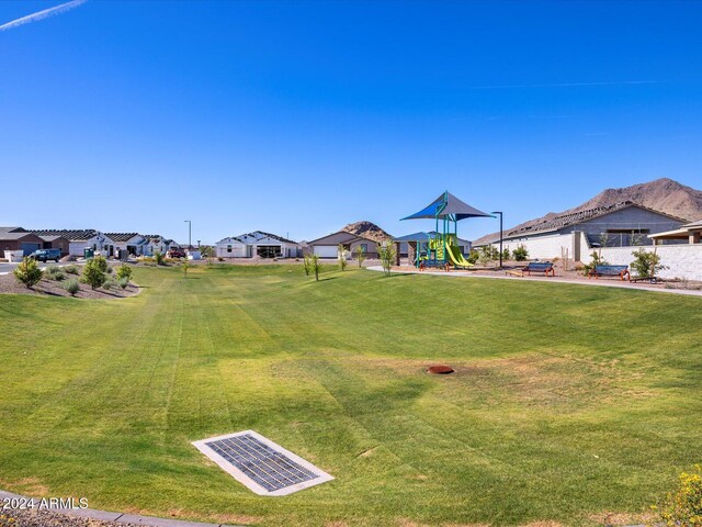 view of yard featuring a residential view, playground community, and visible vents