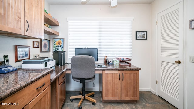 office with built in desk and ceiling fan