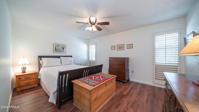 bedroom featuring multiple windows, a textured ceiling, dark hardwood / wood-style floors, and ceiling fan