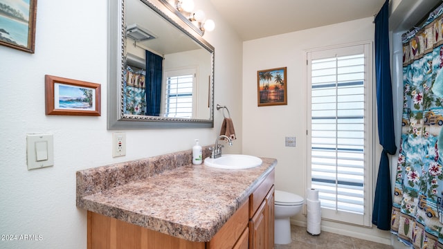 bathroom with vanity, toilet, and tile patterned floors