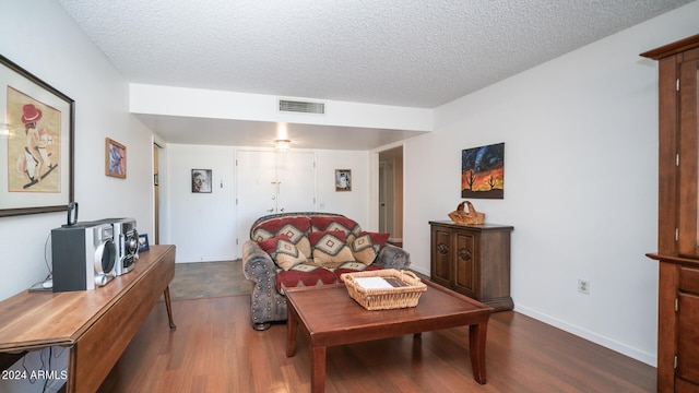 living room featuring a textured ceiling and hardwood / wood-style floors