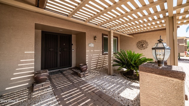 doorway to property featuring a pergola