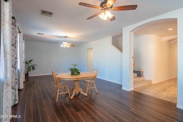 dining space with dark wood-type flooring and ceiling fan