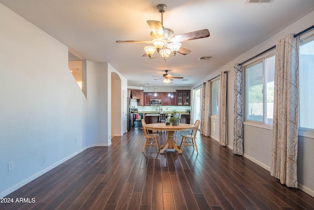 dining room with dark wood-type flooring and ceiling fan