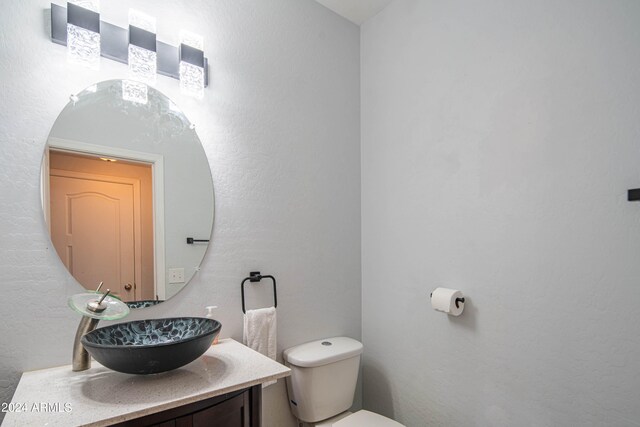 bathroom with toilet and vanity