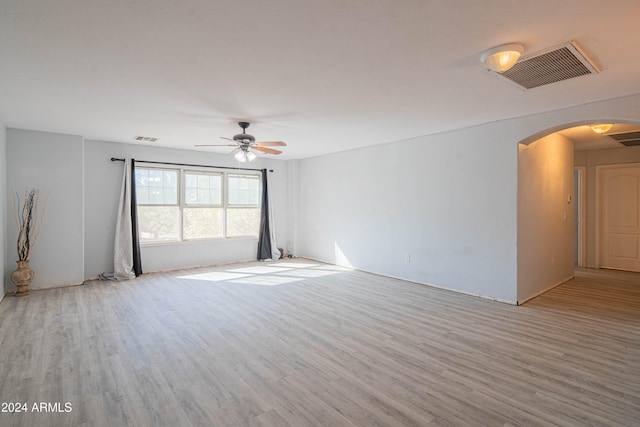 empty room with light hardwood / wood-style flooring and ceiling fan