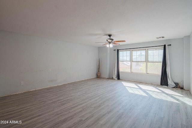 empty room with light hardwood / wood-style floors and ceiling fan