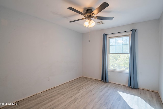 empty room with light wood-type flooring and ceiling fan