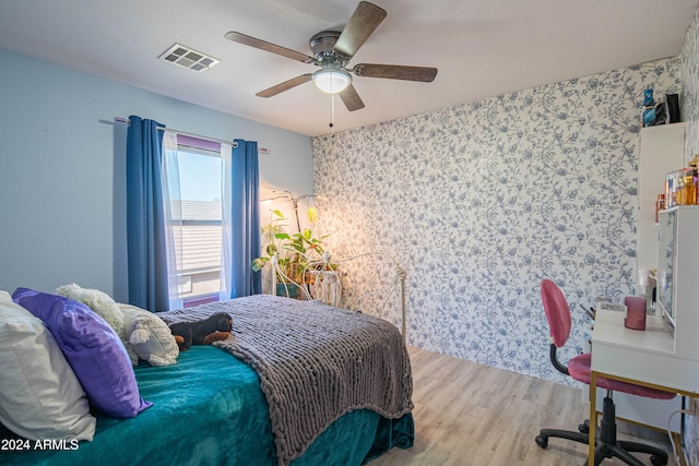 bedroom featuring ceiling fan and hardwood / wood-style flooring