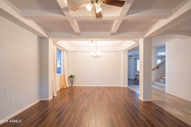 empty room featuring coffered ceiling, dark hardwood / wood-style floors, and a healthy amount of sunlight