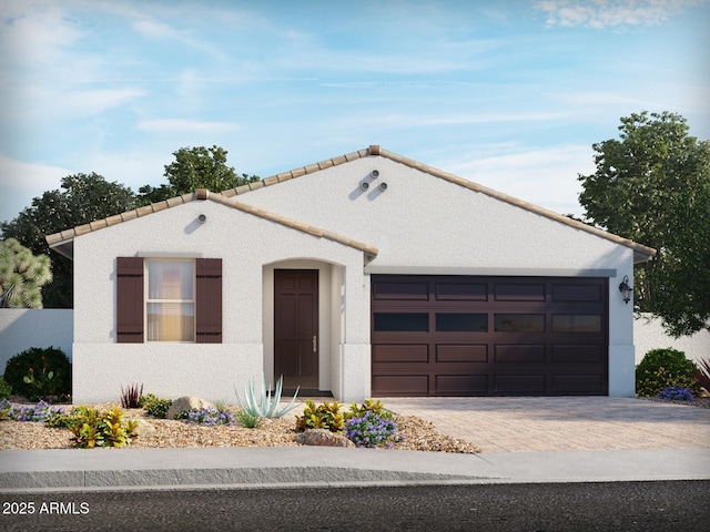 view of front facade with an attached garage, a tile roof, decorative driveway, and stucco siding