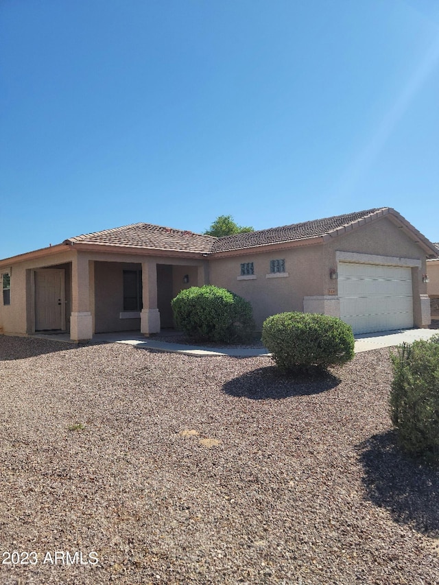 single story home featuring an attached garage and stucco siding