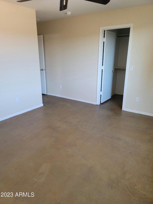 unfurnished room with concrete floors, baseboards, and a ceiling fan