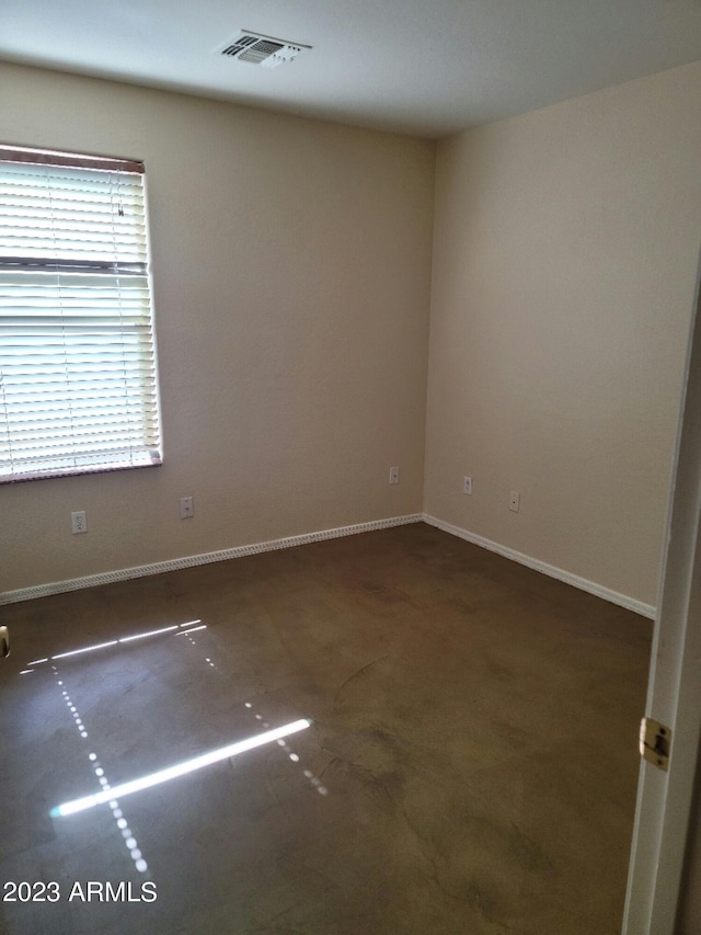 spare room featuring baseboards and visible vents