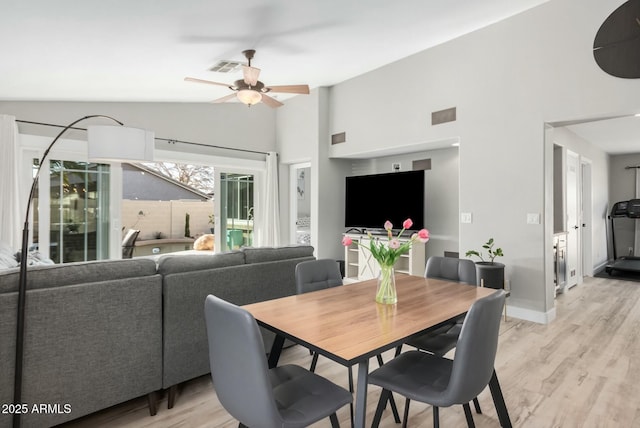 dining area with vaulted ceiling, ceiling fan, and light hardwood / wood-style floors