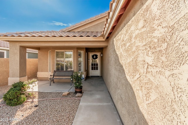 property entrance featuring a patio area