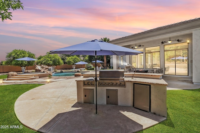 3410 E Inglewood Cir, Mesa, AZ 85213 - patio terrace at dusk featuring a fenced in pool, a fenced backyard, grilling area, and an outdoor kitchen