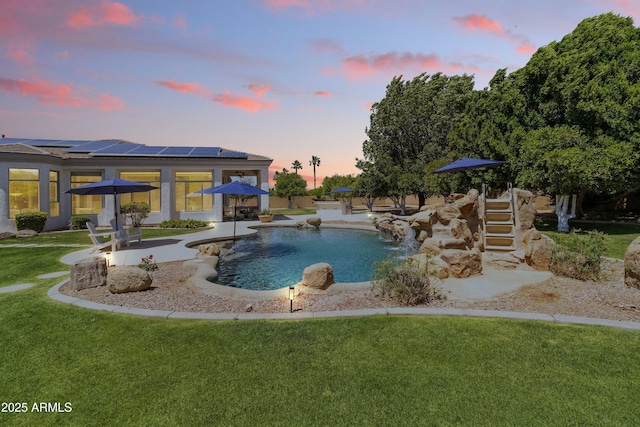 3410 E Inglewood Cir, Mesa, AZ 85213 - pool at dusk featuring a yard, a patio area, and an outdoor pool