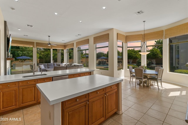 3410 E Inglewood Cir, Mesa, AZ 85213 - kitchen with visible vents, a sink, light countertops, open floor plan, and light tile patterned flooring