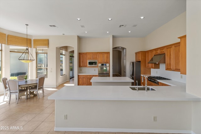 3410 E Inglewood Cir, Mesa, AZ 85213 - kitchen featuring visible vents, a sink, under cabinet range hood, arched walkways, and stainless steel appliances