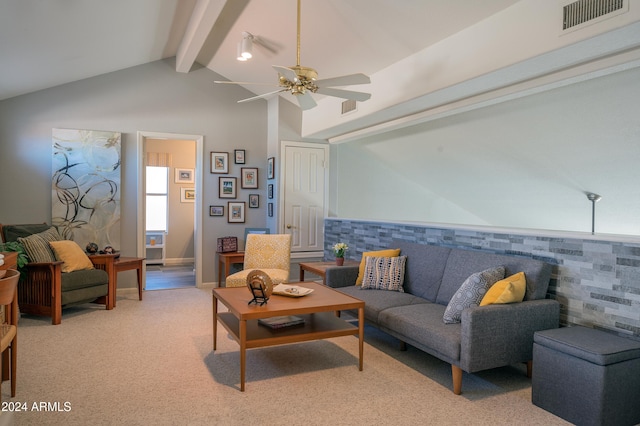 carpeted living room featuring vaulted ceiling with beams and ceiling fan