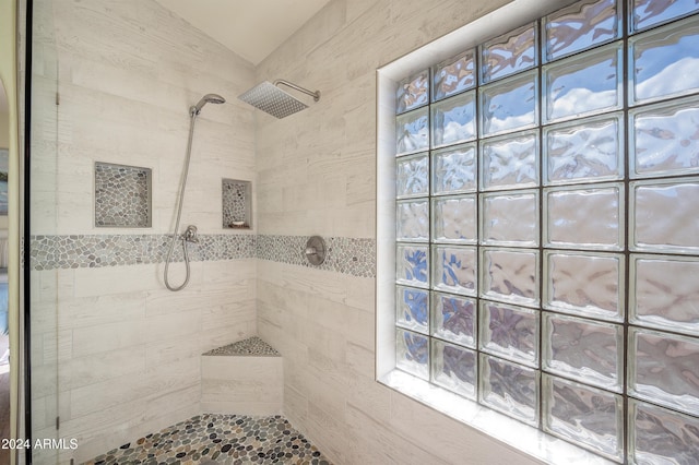 bathroom with tiled shower