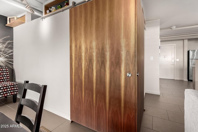 interior space featuring stainless steel refrigerator and tile patterned flooring