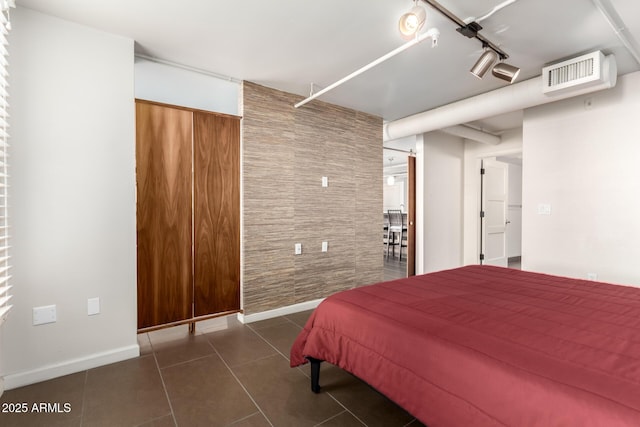 tiled bedroom with track lighting