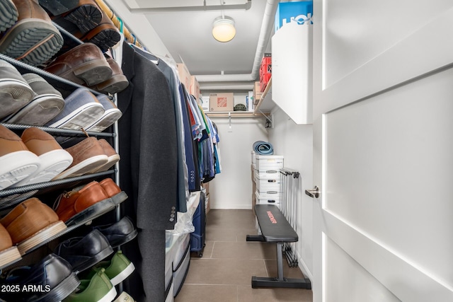 walk in closet with tile patterned flooring