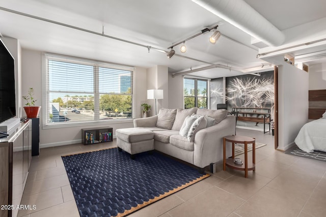 living room with rail lighting, light tile patterned floors, and a wealth of natural light