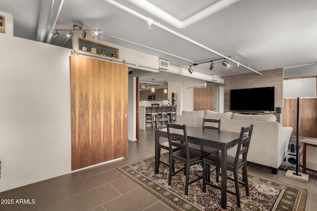 tiled dining area featuring a barn door