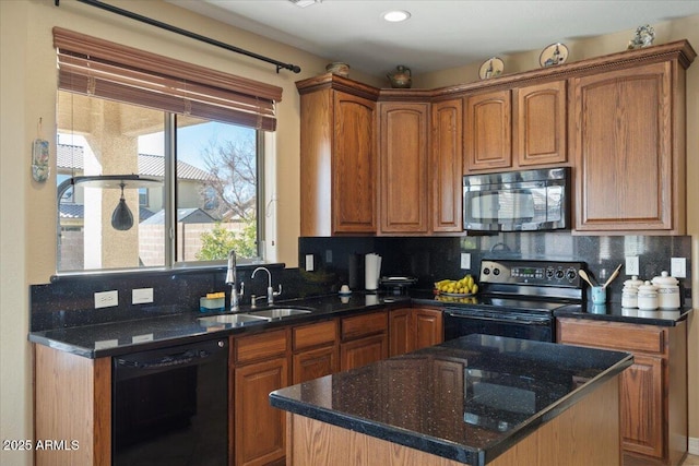 kitchen featuring tasteful backsplash, black appliances, a center island, and dark stone counters