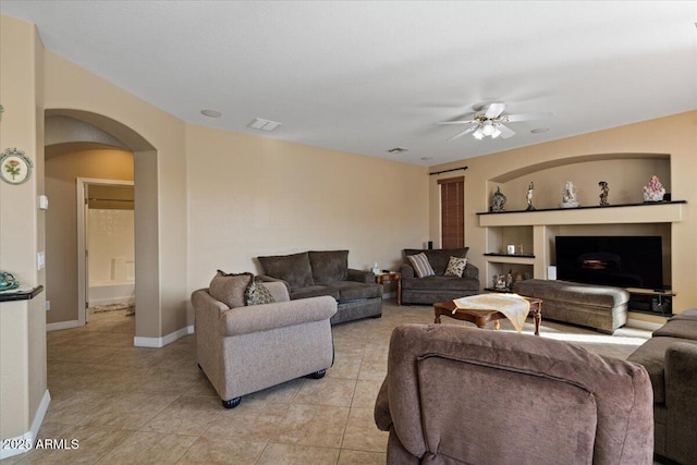 tiled living room featuring ceiling fan