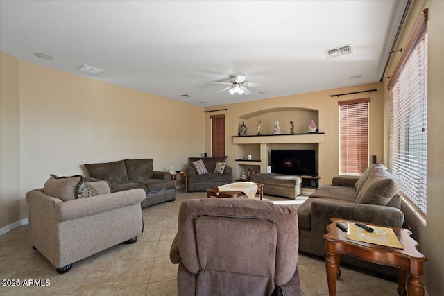 tiled living room with ceiling fan